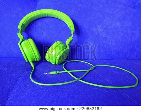 Vivid colour music headphones on a bright color sofa background