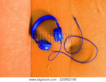 Vivid colour music headphones on a bright color sofa background