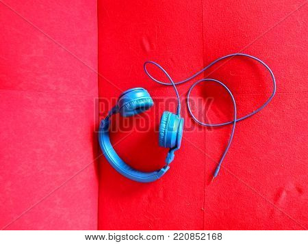 Vivid colour music headphones on a bright color sofa background