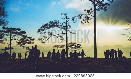People watching Sunrise in the morning. Tourists travel relax in the holiday. photograph sunrise in the morning among people. Thailand