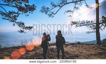 Photographer lover women and men asians travel relax in the holiday. Photograph sunrise in the morning among people. In the winter. In Thailand