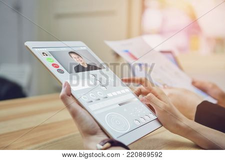 Business women are using a tablet screen with a video call teams. Video Calling is a technology that makes communication fast and error-free.