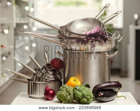 Stack of professional kitchen pans. Restaurant cooking untensils. Healthy food and proper nutrition concept