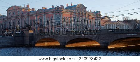 ST. PETERSBURG, RUSSIA - DECEMBER 27, 2015: Traffic on the Anichkov bridge against the Belosselsky-Belozersky Palace. The bridge was built in the present form in 1841, decorated with horse statues