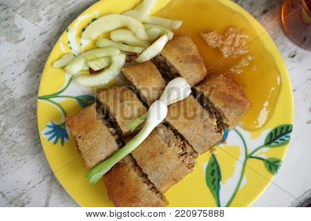 Lumpia /lunpia is a spring roll of Chinese origin commonly found in Indonesia. Originally made by Chinese immigrants, this lumpia is filled with bamboo shoots, dried shrimp, chicken, and/or prawns.