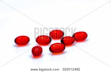 Red Soft Gel Capsule Pills Isolated On White Background. Pile Of Red Soft Gelatin Capsule. Vitamins 
