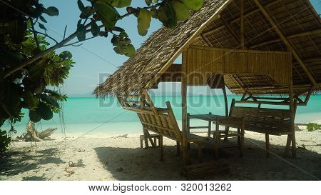 Tropical Beach With Bungalows Under Palm Trees Of Daco, Philippines. Summer And Travel Vacation Conc