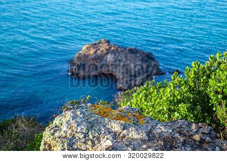 Exotic Cliff Rock, Background Sea 

Light Brown Color Rocks And Cliff, Waves Hitting The Rocks