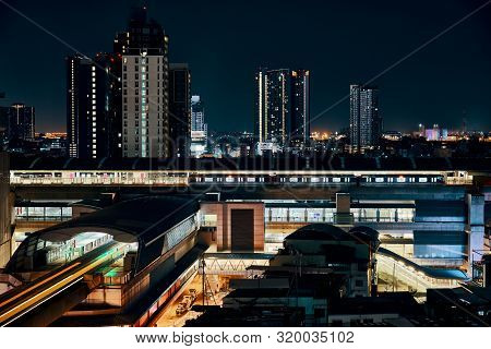 Night View Of Bts Sky Train Running In Downtown Of Bangkok