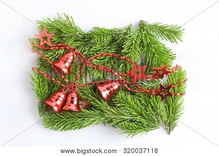 Creative Christmas Composition. Red New Eyar Garland On The Branches Of Spruce. Minimal Layout, Top 