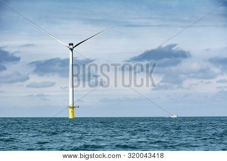 Wind Turbine Out At Sea On Sunny Day