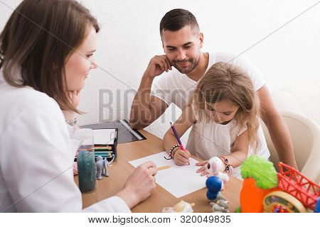 Father With His Child At At Child Psychologists Office. Child Psychologist Taking Care Of The Mental