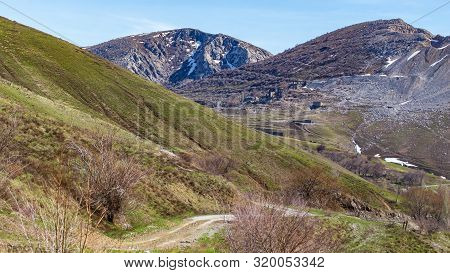 Rocks In The Mountains Against The Blue Sky.