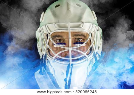 Detail Of A Male Face In A White Goalie Hockey Mask And  Blue And White Smoke.this Is A Detail Hocke
