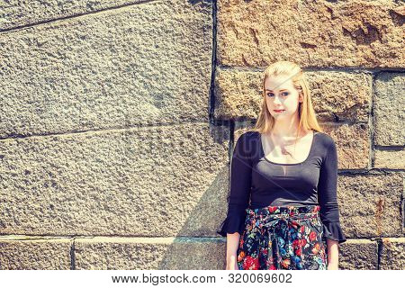 Young American Teenage College Student With Long Blonde Hair, White Skin, Wearing Black Long Sleeve 