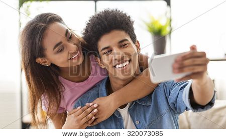 Capturing Happy Moments. Closeup Of Joyful Young Couple Making Selfie On Smartphone Camera While Hav