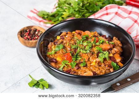 Chili Con Carne From Meat, Beans And Vegetables In Black Plate On Stone Table. Traditional Mexican F