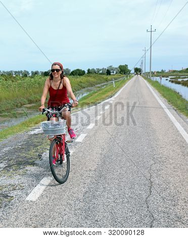 Pretty Woman On The Red Bike In Summer