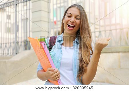 Happy Student Girl Doing Student Exchange Programme In Italy. Excited Young Woman Raising Fist Up Ou