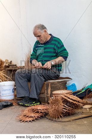 Camacha, Madeira, Portugal - April 19, 2018: A Basket Weaver At Work In The Factory Shop In Camacha 