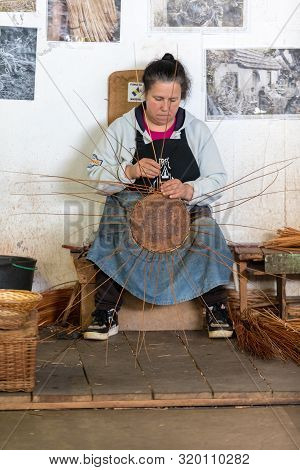 Camacha, Madeira, Portugal - April 19, 2018: A Basket Weaver At Work In The Factory Shop In Camacha 