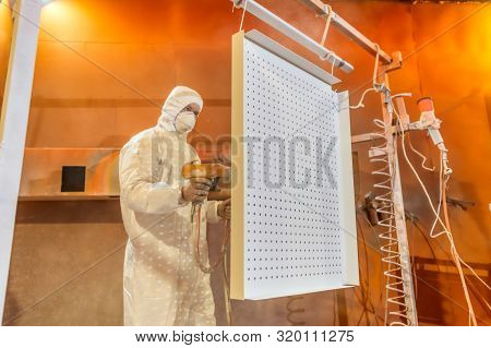 Moscow, Russia - June 18, 2019: Work Paints A Metal Panel. Painting Of Metal Products In An Electros