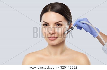 There Is A Woman, Who Is Making The Procedure Microdermabrasion Of The Facial Skin In A Beauty Salon