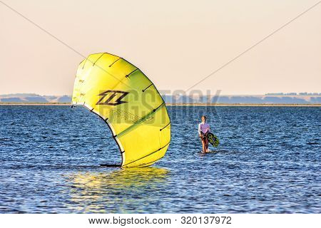 Anapa, Russia - August 20, 2012: Kitesurf Rider Stands In The Water Holding Kite At Blaga Beach Reso