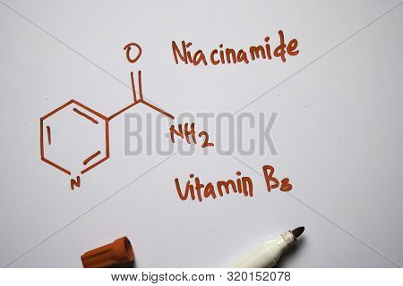 Niaoinamide (vitamin B3) Molecule Written On The White Board. Structural Chemical Formula. Education