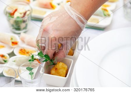 Closeup Catering Chef In Transparent Rubber Glove Put Appetizers In Sauceboats, Fried Brie Cheese, C