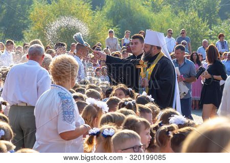 02.09.2019 - Lutsk, Ukraine. Christin Church Preist Hose Down Children With Holy Water As A Blessing
