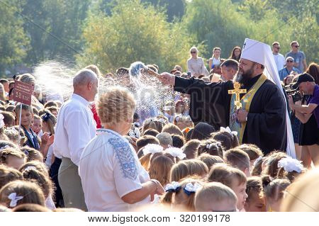 02.09.2019 - Lutsk, Ukraine. Christin Church Preist Hose Down Children With Holy Water As A Blessing
