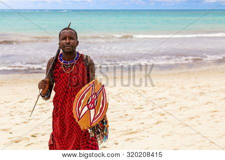 Diani Beach, Ukunda, Kenya - August, 2019: African Maasai Warrior With Spear And Shield At The Diani
