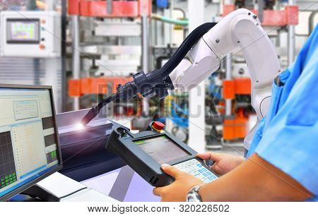 Engineer Check And Control Modern High Quality Automation Welding White Robots Arm At Industrial