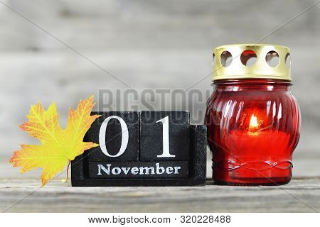 All Saints Day. Votive Candle, Wooden Calendar And Yellow Autumn Leaf
