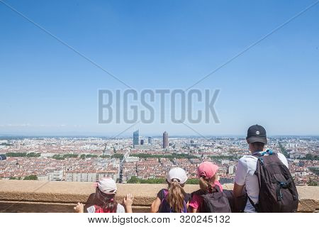 Lyon, France - July 19, 2019: Aerial Panoramic View Of Lyon With Children Tourists Pointing At The S