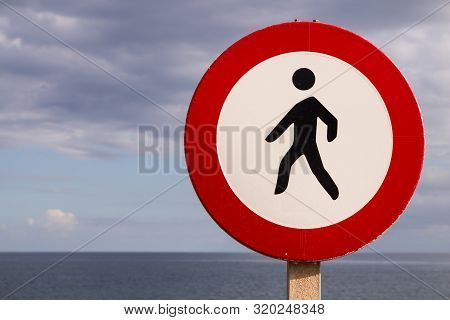 No Passants Traffic Sign At A Coast Line. Atlantic Ocean In The Part Of The Background. Intense Clou