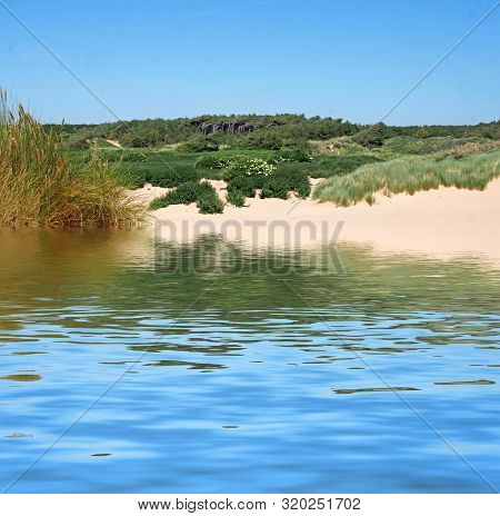 The Beach Rom The Sea At Formby With Dunes Covered In Marram Grass And Vegetation With Forest Landsc