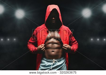 Boxer Man Workout In Boxing Ring. Black Fighter In Hoodie, Stadium Lights Background