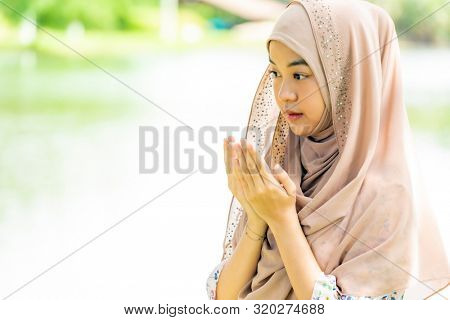 Young Adult teenager Woman making Duas for Muslim god blessing prayer.
