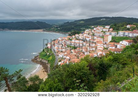 Lastres A Fishermen Village In Asturias, Spain. White Village With Red Roofs