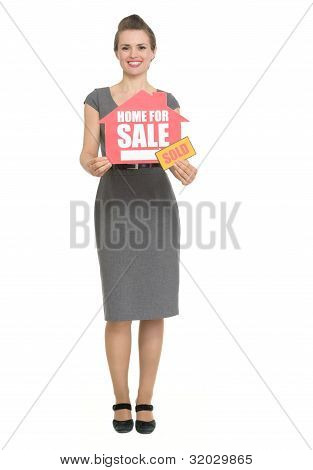Smiling Realtor With Home For Sale Sold Sign Isolated