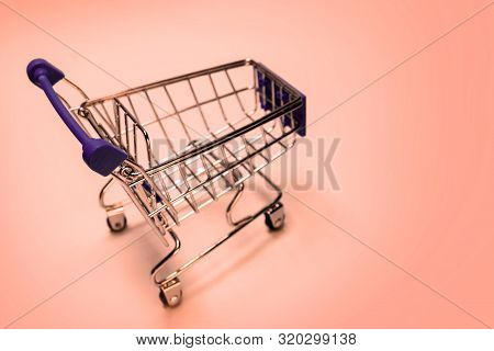 Shopping Cart On A Pink Background. Concept Festive Sale Online, Christmas And New Year Discounts, B