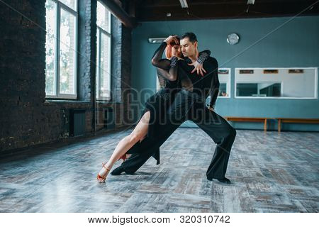 Two dancers in costumes on ballrom dance training