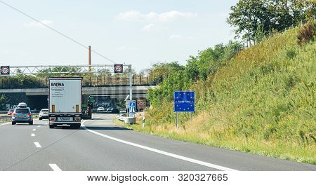 Netherlands - Aug 22, 2019: Truck Driving Past The Nederland Sign At The Border Between Germany And 
