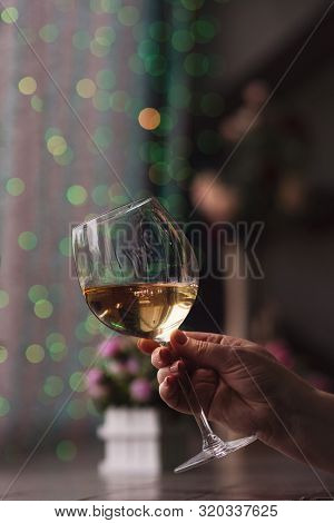 Hand Sommelier Holding Glass Of White Wine. Swirling Wine Glass In Wine Tastings  White Wine Concept