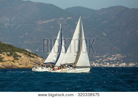POROS, GREECE - OCT 11, 2018: Sailboat participate in sailing regatta 20th Ellada Autumn 2018 among Greek island group in the Aegean Sea, in Cyclades and Saronic Gulf.