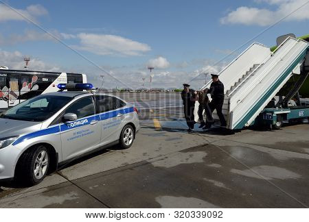 Moscow, Russia - April 26, 2018:police Officers Take Aircraft Brawler Off The Plane