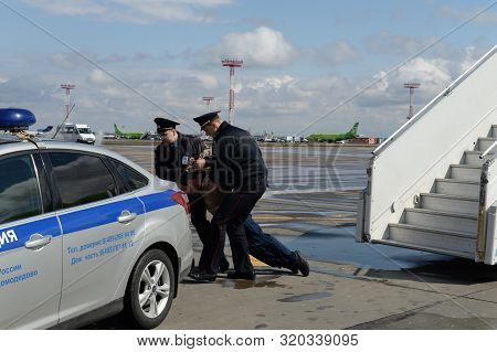 Moscow, Russia - April 26, 2018:police Officers Take Aircraft Brawler Off The Plane