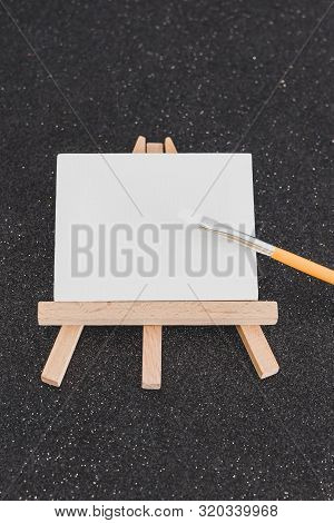 Mini Blank Canvas And Paintbrush With Copyspace